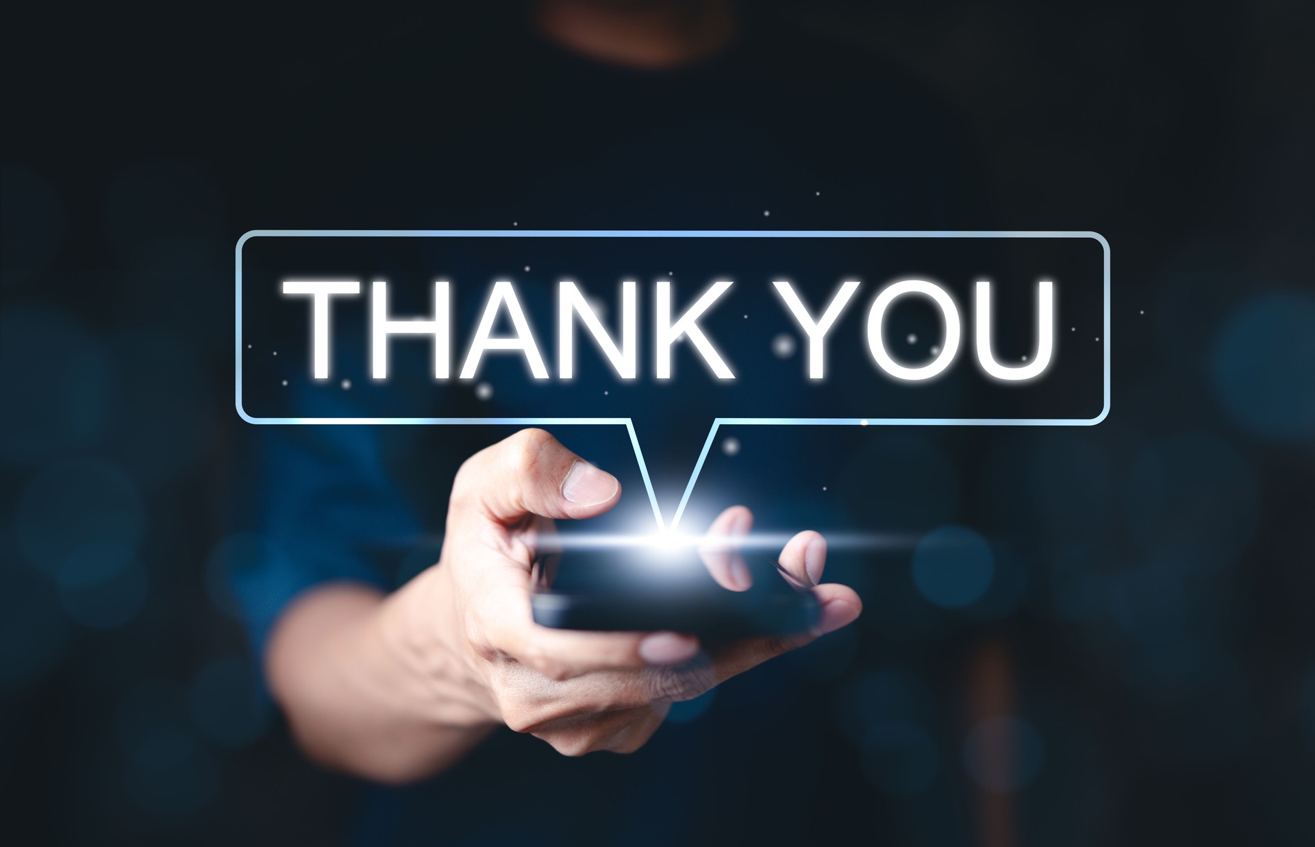 Thank you message concept. A person holding smartphone with glowing "Thank You" message, symbolizing appreciation and gratitude in digital communication. Gratitude, customer service, and interaction.
